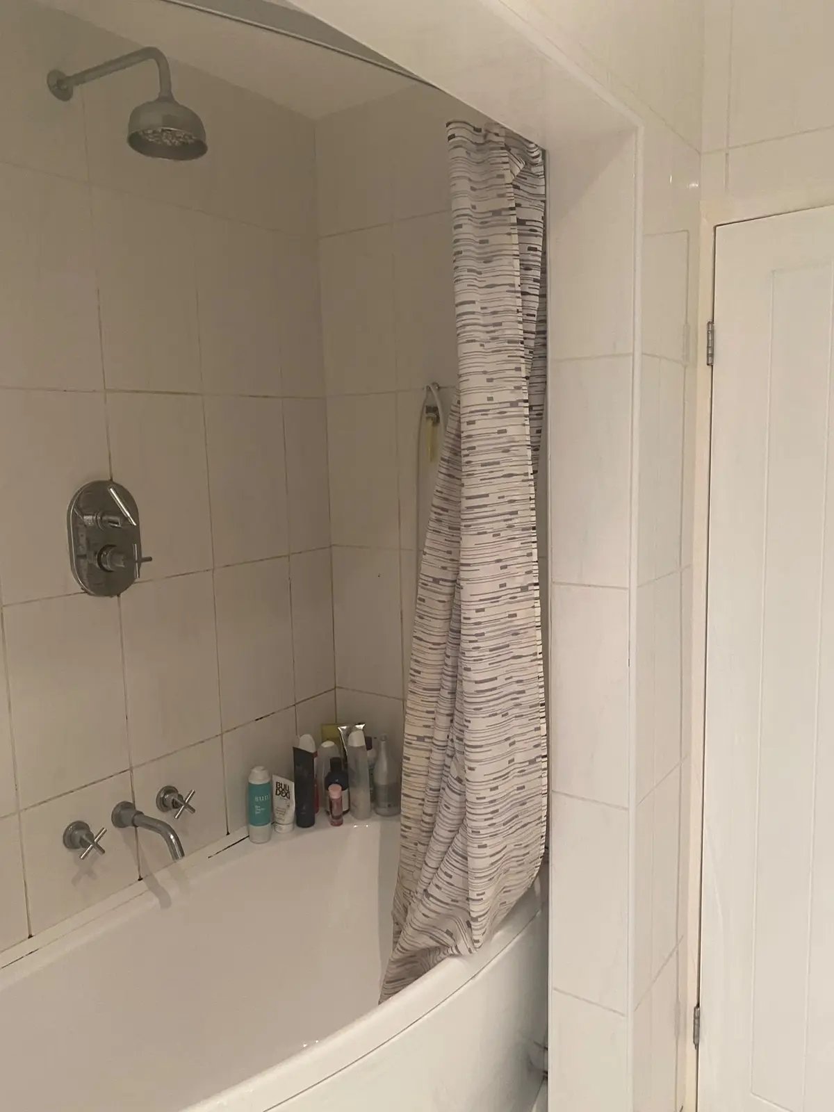 The original bath with a shower over it