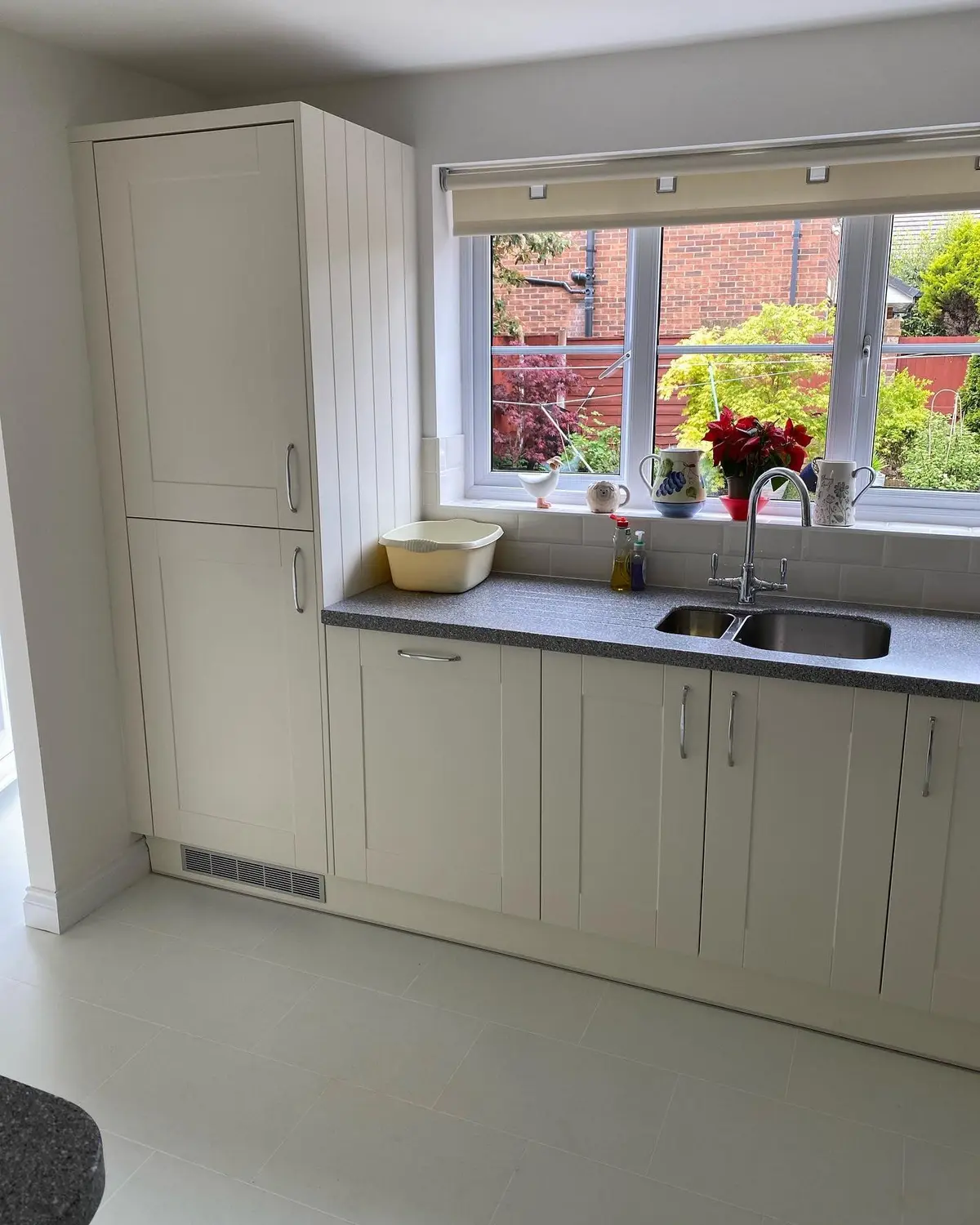 Cream shaker kitchen with grey quartz worktops after a full renovation in Halewood