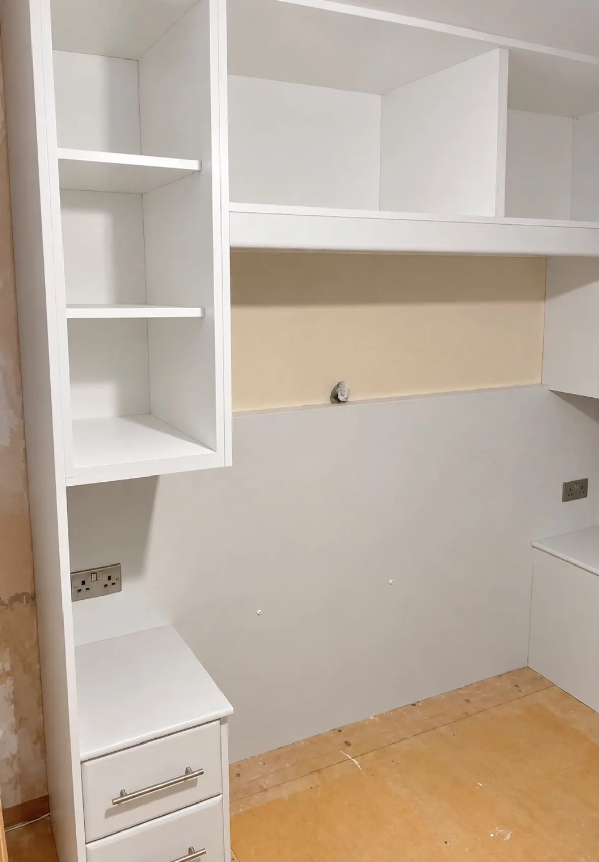 Open shelving and bedside drawers during installation