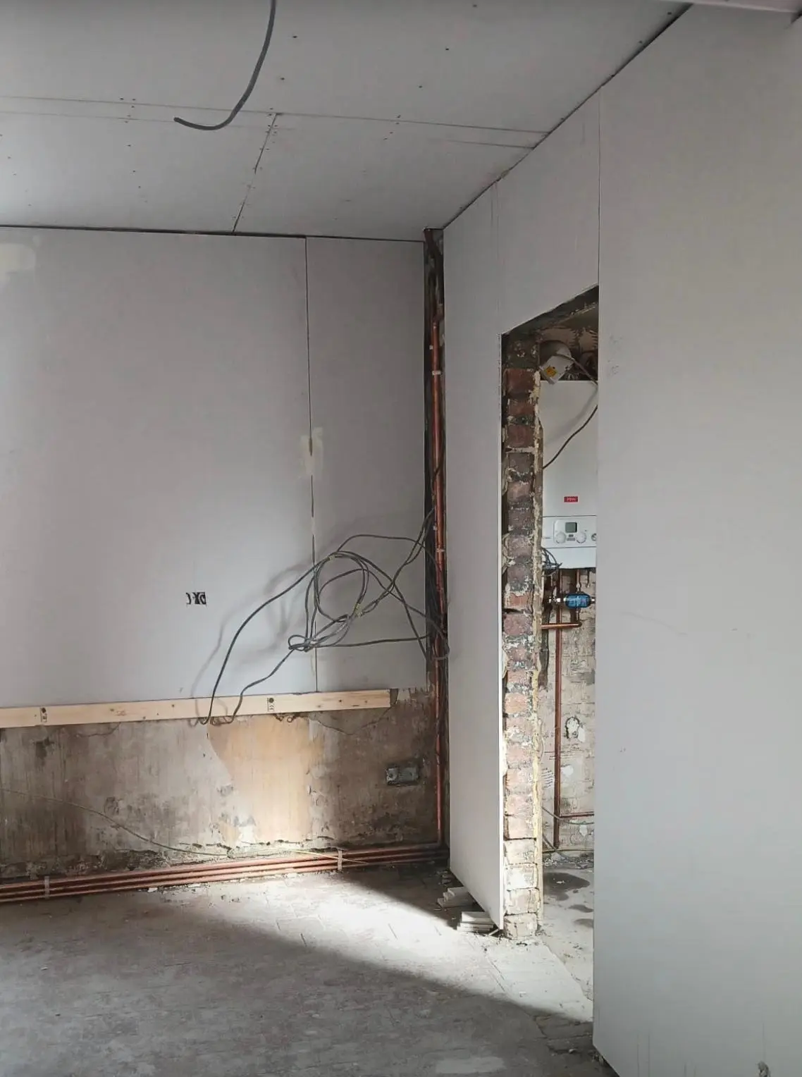 New plasterboard going up in the opened-up room