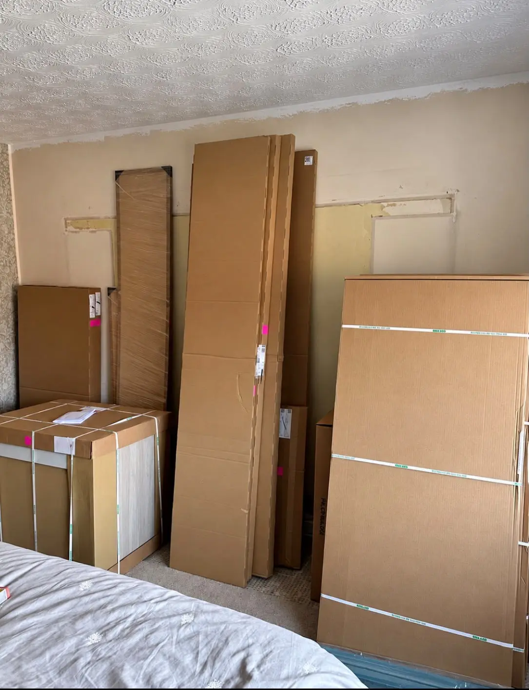 Flat-packed wardrobe boxes delivered before the build