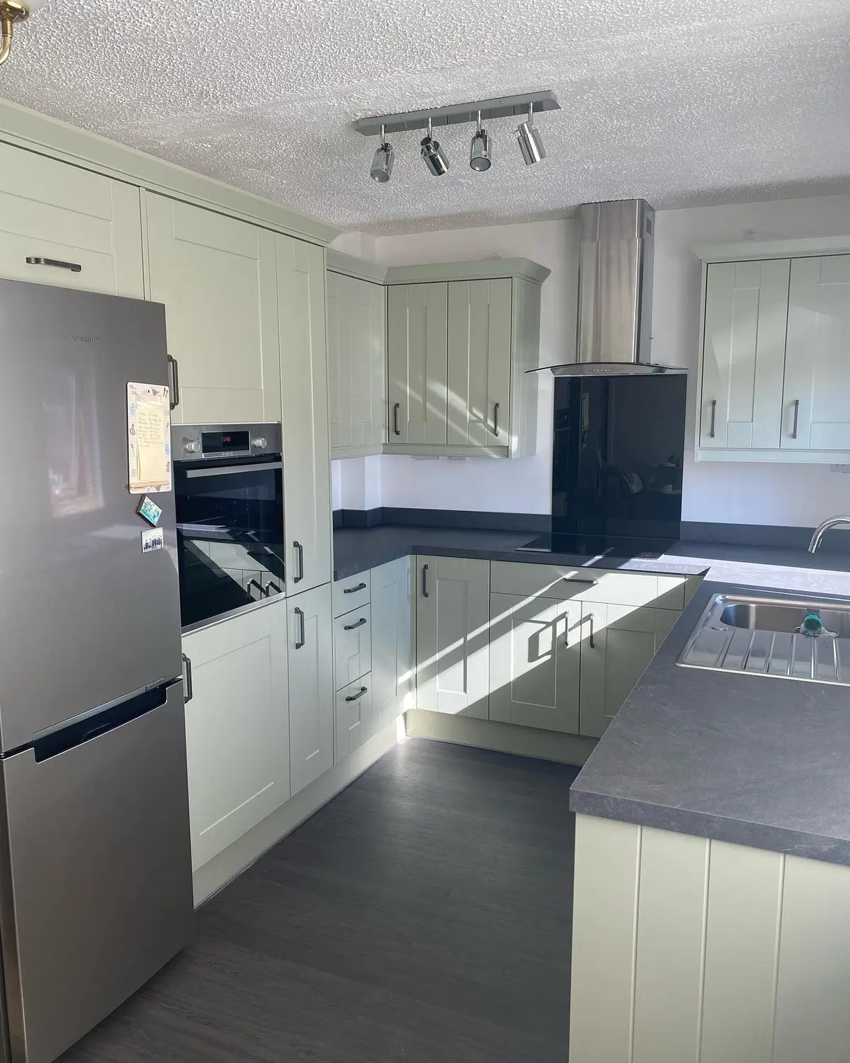 Sage shaker corner units with grey worktop