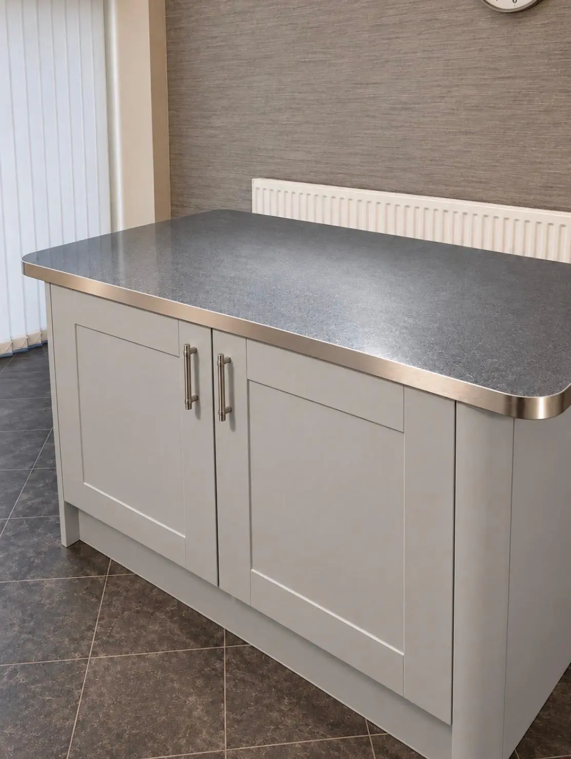 Shaker island with a grey sparkle worktop and stainless edge trim