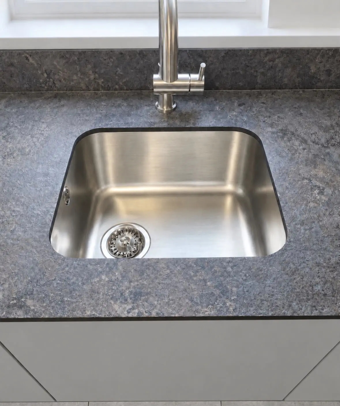 Undermount stainless sink set into the compact laminate worktop