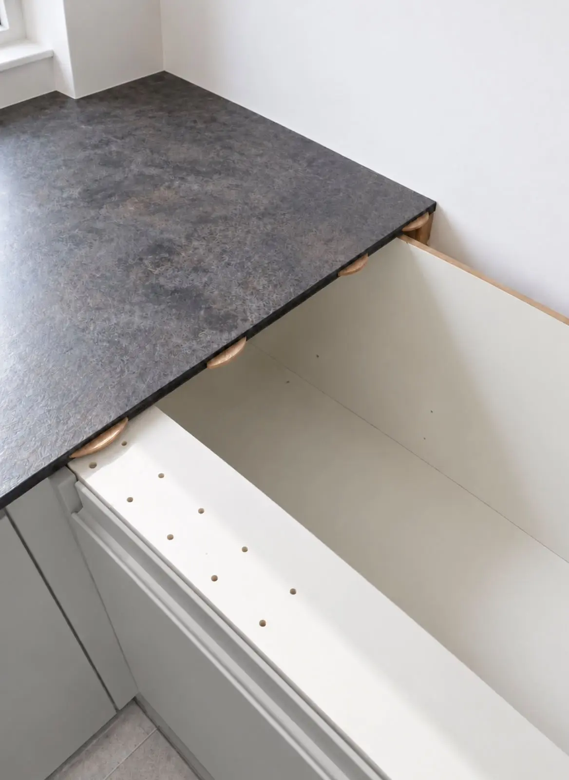 Compact laminate worktop being fitted over the base units